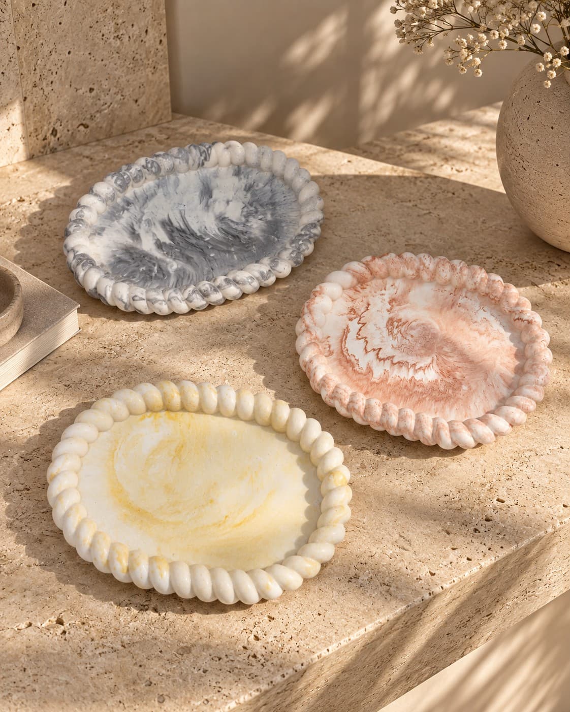 The Arivo tray collection — black, terracotta and ochre marble — styled together