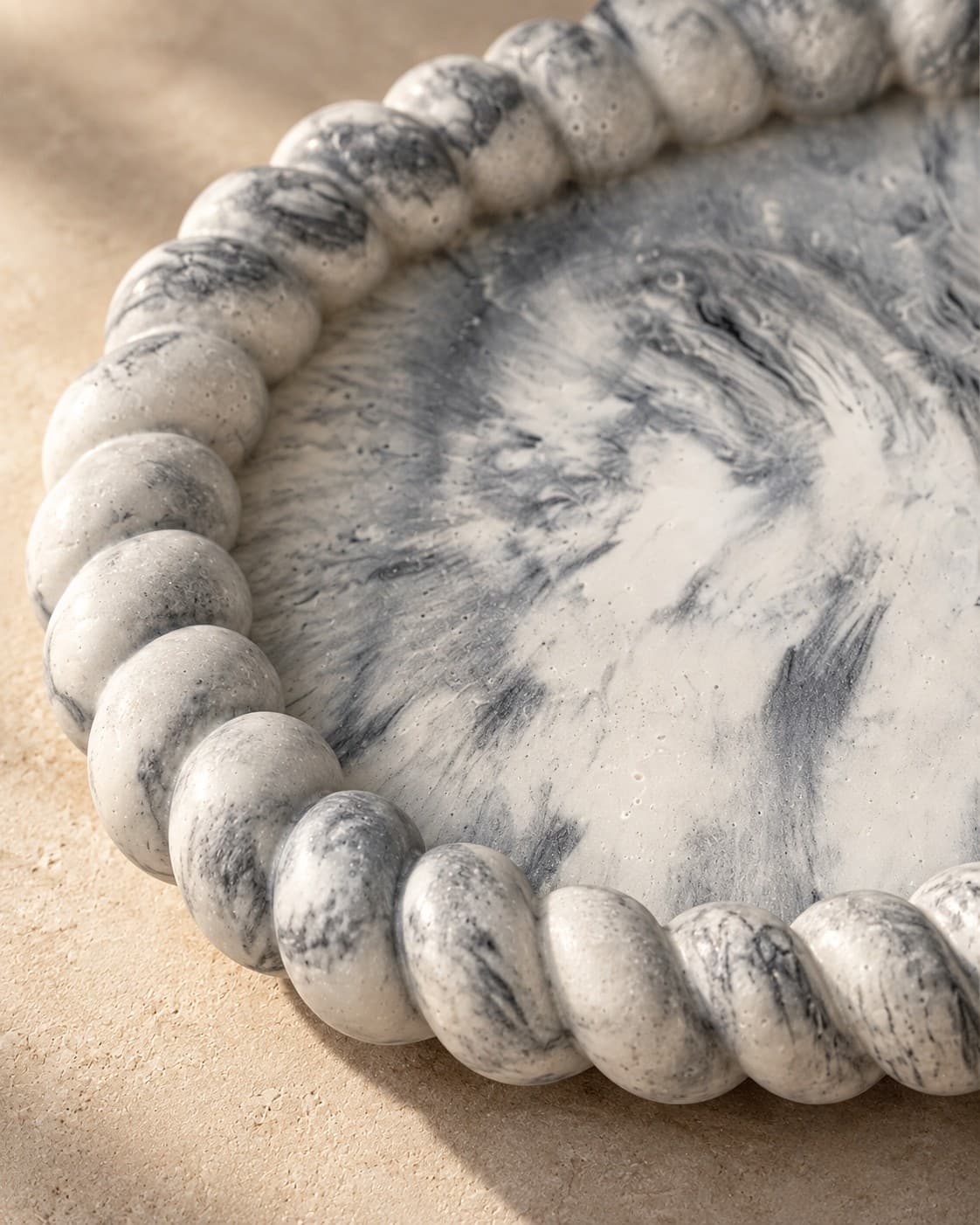 Close-up of hand-finished black marble texture and rope-edge detail